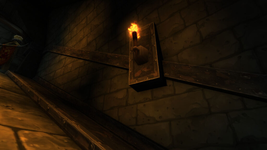 A torch on a dark dungeon wall